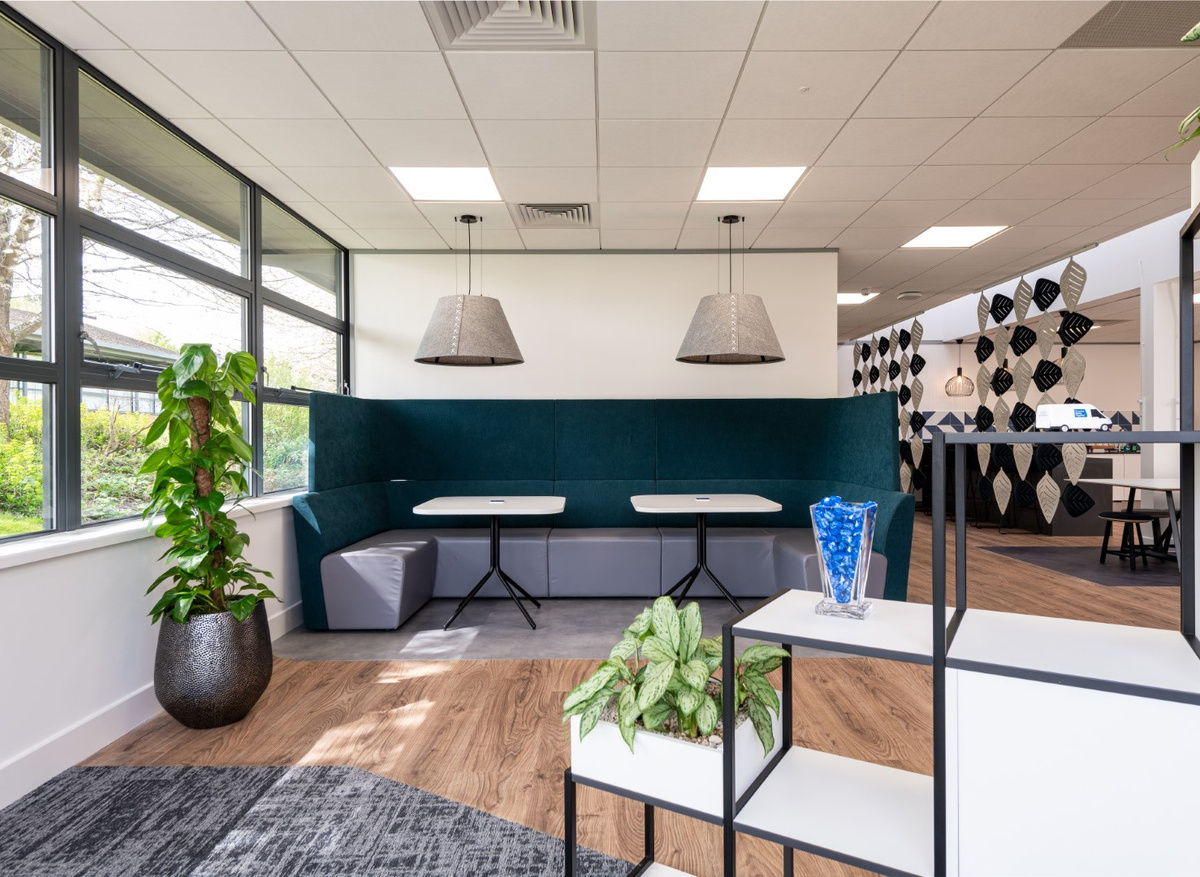 Banquet seating in office breakout space with feature pendant lighting 
